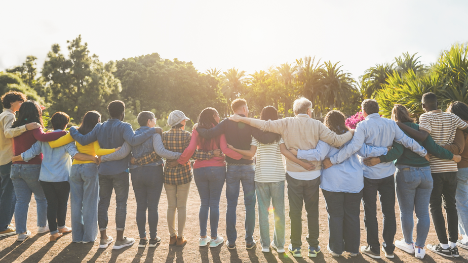 ESG-ProgramHeaderBanner-924x520px-iStock-1472932742 Group of multigenerational people hugging each others - community, social support, multiracial and diversity.