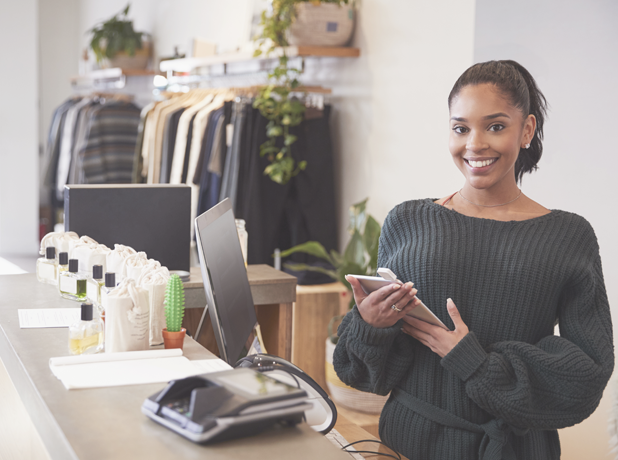 EST -BodyImage-istock901866542-618x460px Female assistant smiling from the counter in clothing store