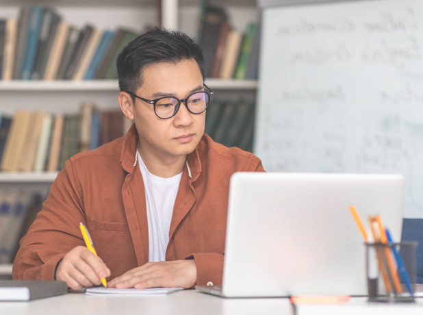 FinancialSupport-MediaTextSplitModule-618x460px-iStock-1470439991 Korean middle-aged trainer using laptop and preparing for a training session.