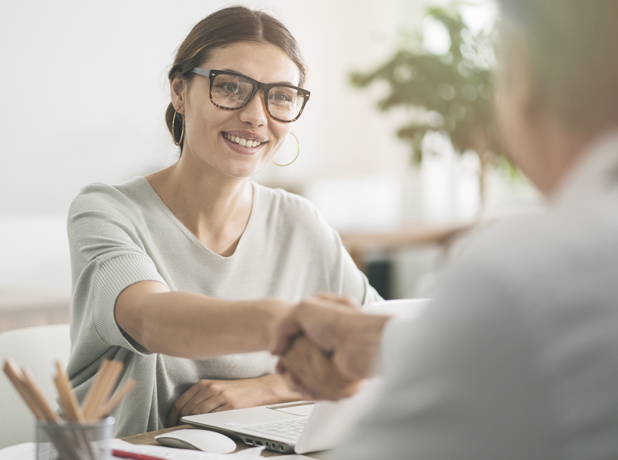 Full Image - Media and Text Split 618x460px_iStock-1007121872 Woman in business meeting shaking hands.