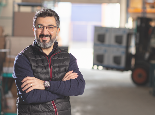Full Image - Media and Text Split 618x460px_iStock-1208802800 Adult man in factory looking at the camera and smiling.<br />