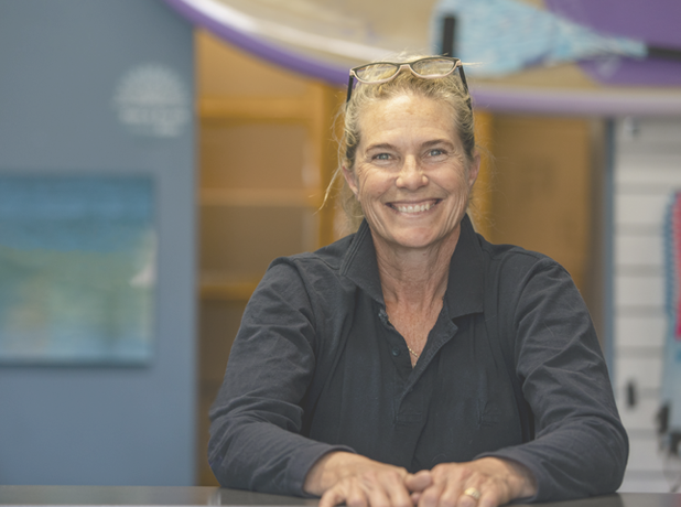 Full Image - Media and Text Split 618x460px_iStock-1224622265 A shot of a mature woman stood at the desk of a surf shop in Perth, Australia.