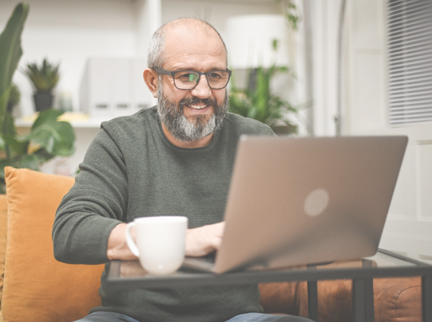 SEA -BodyImage-istock1449438167-618x460px Mature man working from home on laptop wearing glasses.