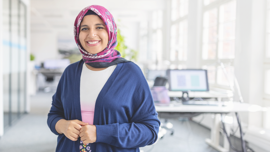 SEE- LPageHeaderBanner-istock1919289294-924x520px Portrait of happy mid adult Muslim woman standing at startup office