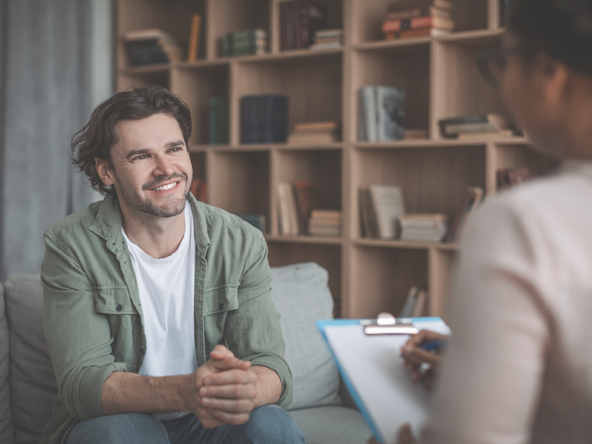 Support-FullBleedModule- MediaandText SplitFull Bleed-858x643px-iStock-1471651485 Adult male seeking advice from a female therapist.