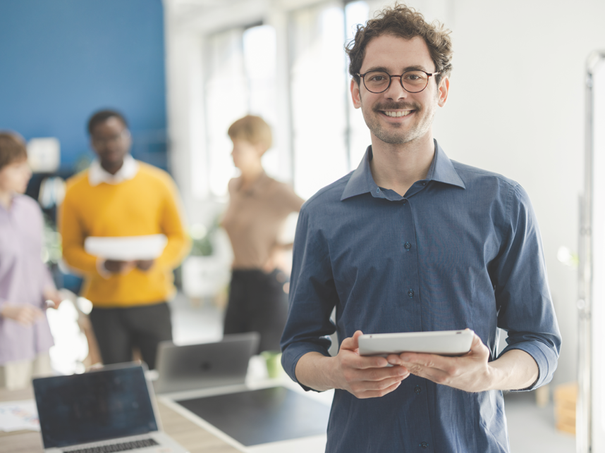 NDIS-FullImage 858x643-iStock-2148849583 Portrait of a young businessman working at his company as a member of a diverse business team.
