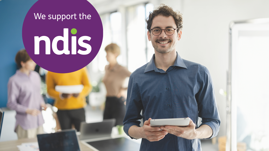 NDIS-ProgramHeaderwithLogo-iStock2148849583-924x520px Portrait of a young businessman working at his company as a member of a diverse business team.
