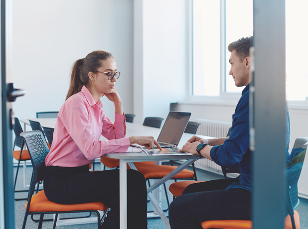SEA -BodyImage-iStock2059384371-618x460px In a sleek and modern office a female discusses her business plan with a a male business advisor.