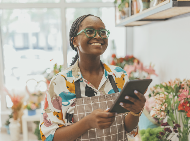 SEA -BodyImageModule-iStock-1569566040-618x460px A 27-year-old African-American female entrepreneur owns a fresh flower shop, using a digital tablet. Stock
