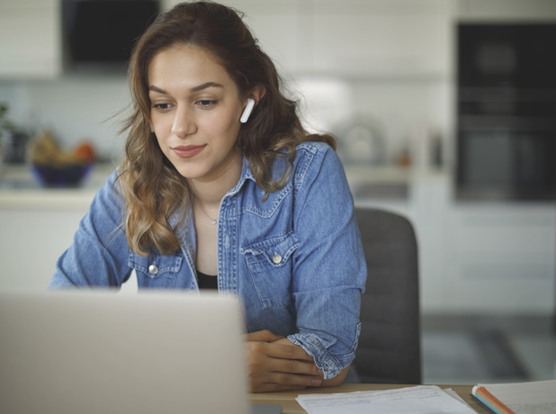 SEA - Full Image - Media and Text Split 618x460px_7c Smiling young woman with bluetooth headphones attends an online course at home