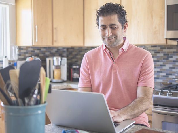 SEE-BodyImageModule-iStock-1295865407-618x460px Mature man looking at laptop working from home kitchen