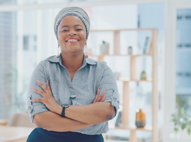 SEE -BodyImageModule-iStock-1770305440-618x460px Portrait, arms crossed and happy black woman in office with smile, pride and senior startup business entrepreneur.