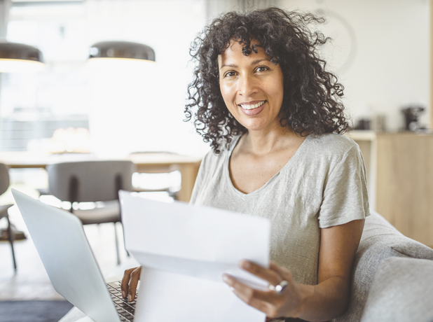 SEE-BodyImageModule-iStock1397497056-618x460px woman working from home smiling at camera