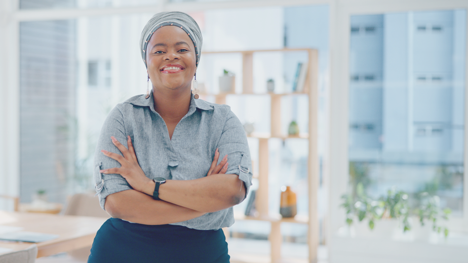 SEE- ProgramHeaderBanner-istock1770305440- 924x520px Portrait, arms crossed and happy black woman in office with smile, pride and senior startup business entrepreneur.