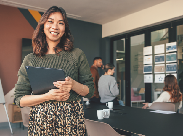 SS - Full Image - Media and Text Split 618x460px_4c(Workplace Skills) Happy Asian businesswoman smiling at the camera in a boardroom.