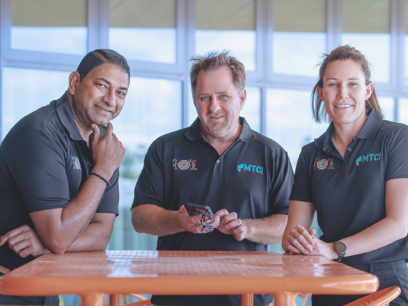 The MTC Difference-CampaignTitleCard-518x440px-MTC_0L6A6897 three MTC staff memebrs smiling at the camera.