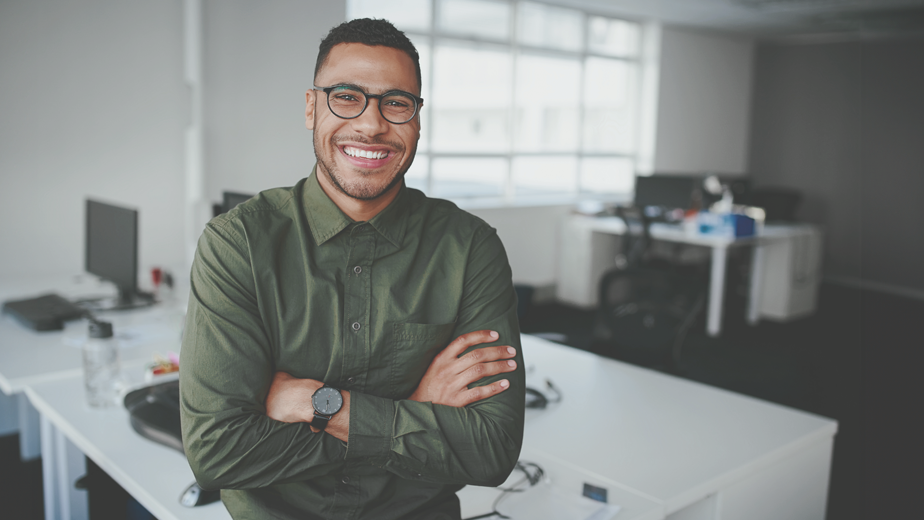 VETTraineeship- ProgramPageHeaderBanner-iStock-1178152960-924x520px Portrait of a happy confident young african american businessman standing with his arms crossed looking at camera.