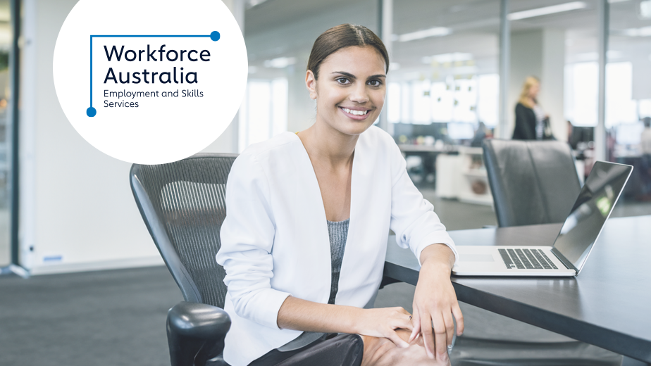 WFA-ProgramHeaderwithLogo-iStock504334780-924x520px Business woman at desk looking at the camera and smiling.