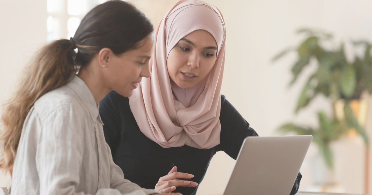 AlliedHealth-Featured Image Size -1200x628px Middle-aged woman wearing glasses smiling and looking at computer while studying.