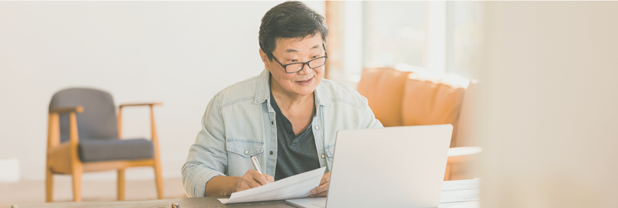 SEE-Campaign Header Banner-iStock-1291988963-1248x420px Cheerful mature-aged Asian businesswoman works on financial statements at home.