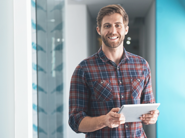 SEE-BodyImageModule-iStock-693275084-618x460px Anglo-saxon man standing with ipad smiling to camera