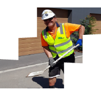 Participant Brendan working outside with a shovel.