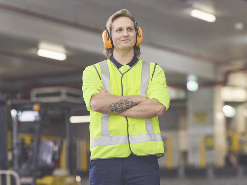 Person wearing hi-vis outfit looking into the distance. 