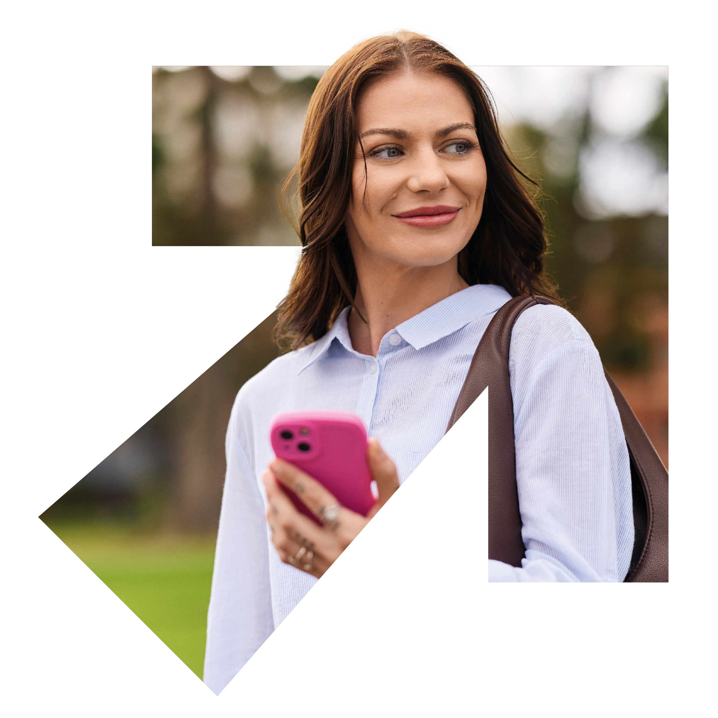 A woman holding her phone looking inspirationally over her shoulder