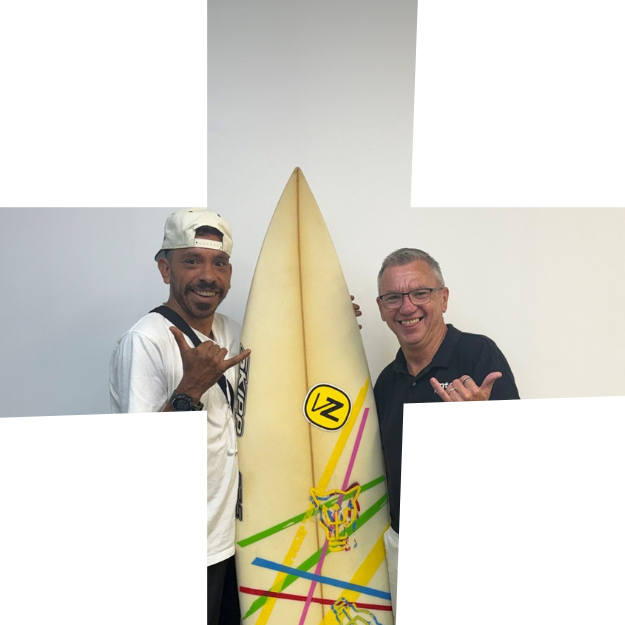 Cody and Lance holding a surfboard