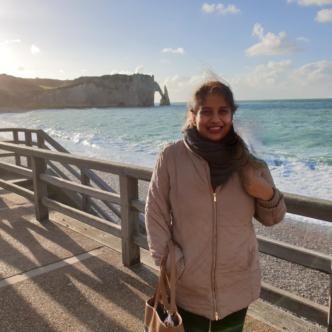 Shamini staning in front of a beach